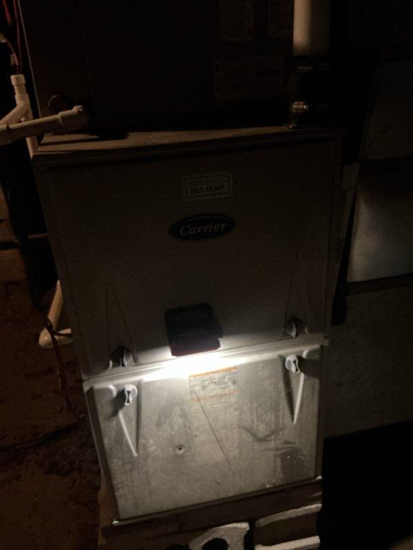 Responded to service call for grinding noise from basement Carrier HVAC system during shutdown cycle. Inspected 10-year-old furnace/air handler unit and outdoor condenser. Performed diagnostic evaluation of blower motor, inducer assembly, and system components during operation and shutdown sequences. Unit maintained adequate heating/cooling capacity throughout inspection. Documented equipment condition with interior furnace compartment and exterior condenser photographs showing standard wear patterns consistent with system age. Vegetation growth noted around outdoor unit requiring clearance maintenance for optimal airflow.