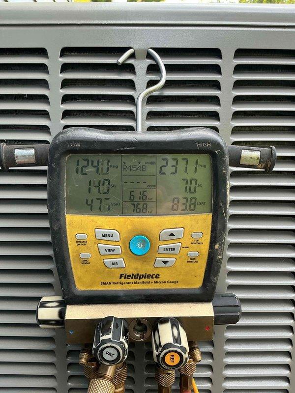 Completed installation of 2-ton, 16 SEER Lennox air conditioning system with matching upflow evaporator coil at residential property. System was properly charged with R454B refrigerant, pressures and temperatures verified using digital manifold gauges, and unit tested for proper operation with all readings within manufacturer specifications.