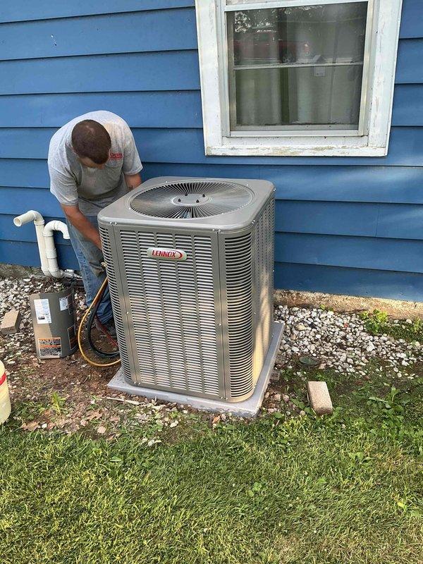 Completed installation of 2-ton, 16 SEER Lennox air conditioning system with matching upflow evaporator coil at residential property. System was properly charged with R454B refrigerant, pressures and temperatures verified using digital manifold gauges, and unit tested for proper operation with all readings within manufacturer specifications.