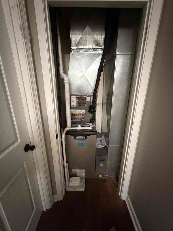 Completed full HVAC system installation including a 2-ton, 15.5 SEER Lennox air conditioning condenser unit positioned on exterior pad with proper clearances, and a 97% AFUE furnace with air handler installed in interior utility closet. All ductwork connections secured, condensate drain line and electrical conduit properly routed, system tested and verified operational to manufacturer specifications.