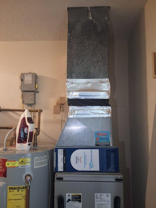 Conducted comprehensive site visit and estimate for residential HVAC system, documenting existing air handler unit, vertical ductwork configuration, and water heater installation in utility room. Captured detailed photos of equipment specifications, manufacturer labels, and current mechanical room layout for proposal preparation and sales follow-up.