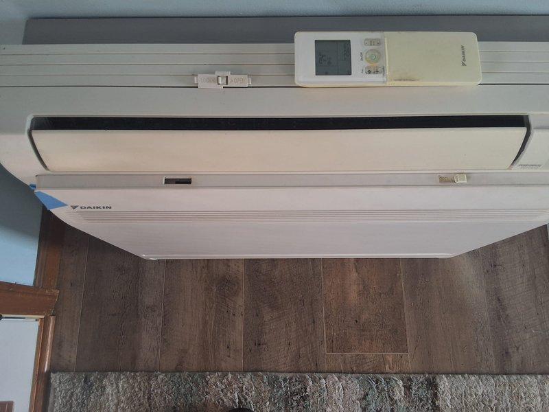 Responded to no-cool complaint on 8-year-old Daikin ductless mini-split system experiencing inadequate cooling performance with lukewarm air discharge and inability to maintain setpoint temperature. Performed diagnostic evaluation of wall-mounted indoor air handler and confirmed proper airflow, verified no refrigerant line restrictions or evaporator coil icing, and assessed system operation through remote controller interface. System operational with normal airflow distribution through louvers at time of service.