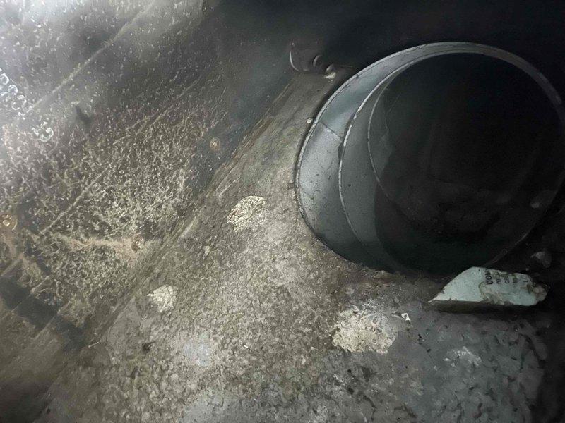 Performed comprehensive heating and cooling load calculations for complete HVAC system replacement. Calculated heating requirements at 89,384 BTUh with 1,161 CFM airflow and cooling requirements at 56,373 BTUh with 2,094 CFM airflow. Documented existing system conditions showing significant dust accumulation throughout ductwork and air handler components, indicating poor filtration and maintenance history. Captured technical data and equipment specifications to develop accurate replacement estimate for properly sized system based on actual load requirements.