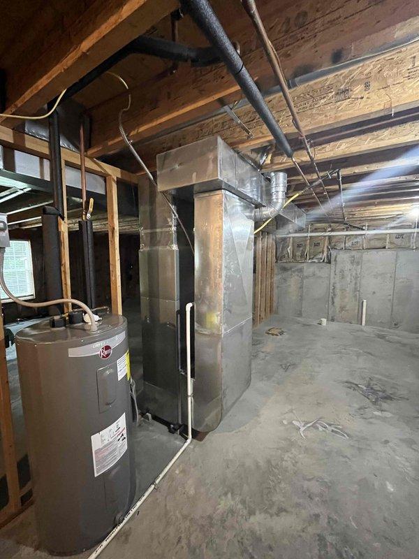 Conducted comprehensive HVAC system replacement estimate at residential property, evaluating existing furnace and mechanical equipment located in unfinished basement area. Assessed current system configuration including ductwork routing, electrical connections, and clearance requirements for replacement equipment. Documented exterior condensing unit location adjacent to foundation with considerations for proper clearances from landscaping and adequate ventilation access for new installation.