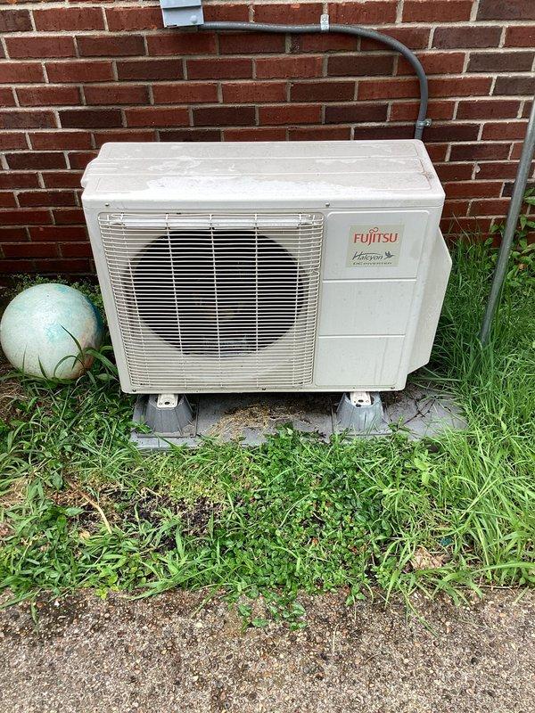 Responded to service call for reduced cooling performance on four-year-old Fujitsu Halcyon mini-split system. Upon arrival, conducted visual inspection of outdoor condenser unit and documented equipment condition with photographs showing unit installed on concrete pad against building exterior with proper clearances maintained. Unit appeared clean with no visible debris obstruction to airflow through ventilation louvers, and refrigerant lines showed proper insulation and secure mounting to structure. Performed standard diagnostic evaluation to assess system operation and identify cause of diminished cooling capacity.
