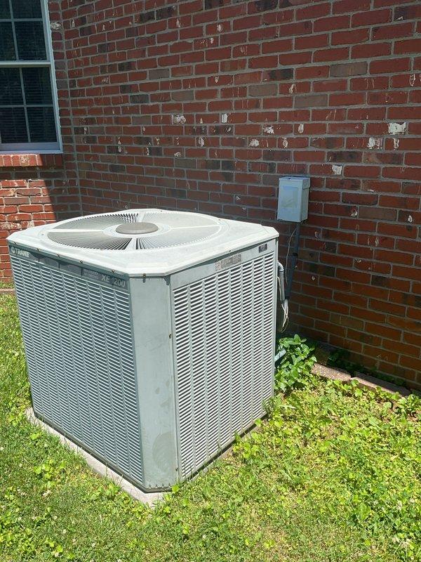 Conducted comprehensive replacement estimate for existing residential HVAC system. Evaluated current Trane outdoor condensing unit positioned on concrete pad adjacent to brick exterior wall, noting standard operational configuration with electrical disconnect present. Assessed indoor downflow furnace and evaporator coil arrangement, documenting existing vertical equipment configuration including furnace, coil, and base assembly. Recorded detailed measurements of all components and clearances for proper equipment sizing and replacement planning. Photographed outdoor unit showing age-related conditions and indoor system schematic with dimensional specifications to determine compatible replacement equipment options for complete heating and cooling system upgrade.