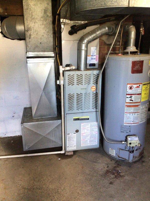 Responded to no cooling complaint on recently installed residential air conditioning system with inadequate temperature control and weak airflow. Upon inspection, discovered slight moisture accumulation near furnace cabinet indicating potential condensate drainage issue or evaporator coil concern. Evaluated newly installed HVAC equipment including air handler, furnace, and associated ductwork in basement utility area. System components appeared properly installed with standard residential configuration. Diagnosed airflow restriction and cooling deficiency, performed necessary adjustments and repairs to restore proper system operation and achieve desired temperature setpoint.