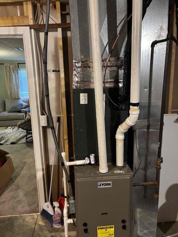 Completed evaporator coil installation on York HVAC system. New evap coil was installed above existing furnace unit with proper refrigerant line connections and condensate drainage. System temperatures verified at 78°F using calibrated digital thermometer, confirming proper operation and cooling capacity restored.