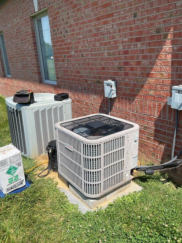 Responded to no-cool service call at commercial dental office for 20-year-old American Standard/Trane 5-ton heat pump system with air handler utilizing R22 refrigerant. Upon arrival, confirmed system had experienced freeze-up condition and customer had initiated proper thaw-out procedure by turning unit off. Inspected dual ground-mounted condenser units located at rear exterior of building and documented equipment model and serial number information from manufacturer data plate. System age and R22 refrigerant phase-out were discussed as factors for potential replacement consideration.