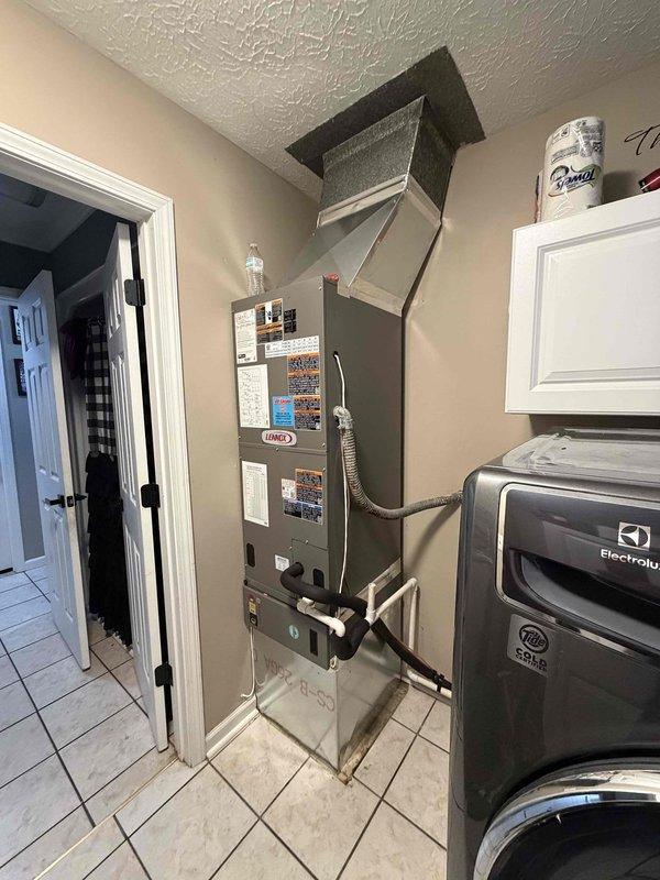 Completed installation of a 2-ton, 19 SEER heat pump system at residential property. Installed Lennox air handler unit in interior utility room with proper ductwork connections and filter compartment, and positioned outdoor heat pump condenser unit on concrete pad adjacent to home exterior with electrical disconnect box and all required connections completed per manufacturer specifications.