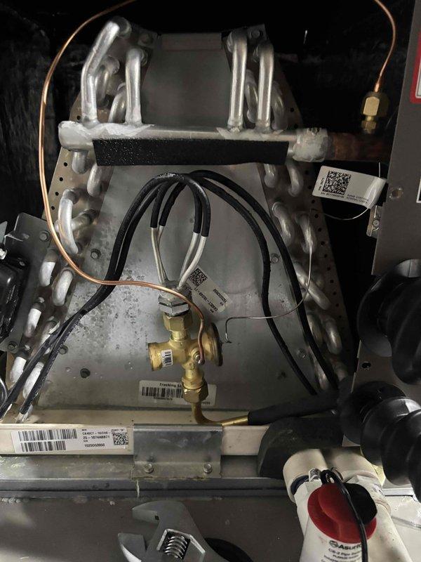 Replaced defective thermostatic expansion valve (TXV) on indoor evaporator coil assembly. Performed system evacuation to 190 microns to verify proper vacuum and system integrity, with decay rate of 57 microns per minute confirming no leaks present. Unit tested and operating within manufacturer specifications.