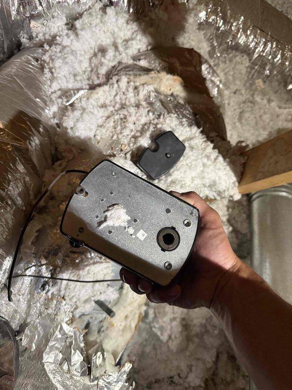 Responded to no cooling complaint on 3-year-old residential HVAC system with airflow present but inadequate cooling. Performed diagnostic evaluation of control board and zone control system, inspecting PCB components, capacitors, and terminal connections. Accessed attic-mounted equipment to examine zone damper actuator and verify proper mechanical operation and wiring connections.