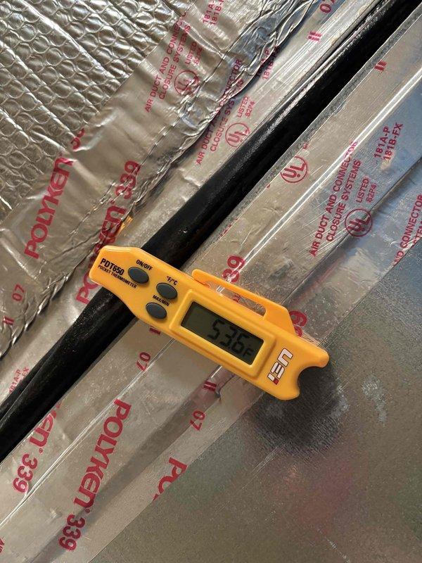 Performed comprehensive AC tune-up on 16-year-old cooling system experiencing slow cooling performance affecting entire home. Conducted thorough system diagnostics including temperature differential measurements across supply and return ducts, recording -8.5°F split at one measurement point and 155°F reading at another location. Inspected all accessible ductwork and insulation for proper installation and integrity. Evaluated system performance parameters to identify causes of inadequate cooling capacity. Completed standard preventive maintenance procedures including filter inspection, electrical connections check, refrigerant level assessment, and overall system operation verification. Observed customer's request for protective foot coverings throughout service visit. Documented findings with photographic evidence of diagnostic measurements and system components for service records.