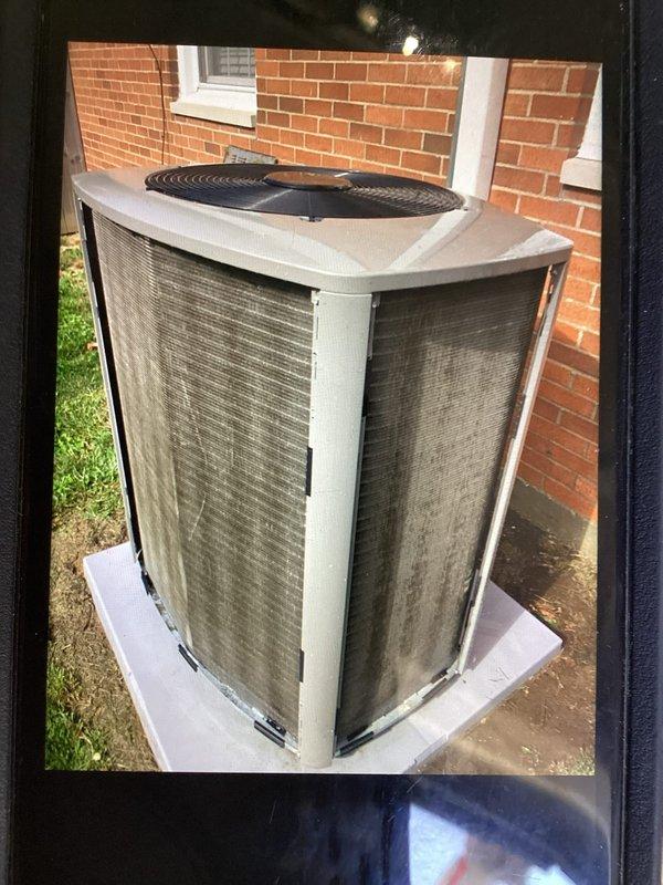 Completed annual planned maintenance on residential HVAC system with outdoor condenser unit positioned on concrete pad adjacent to brick structure. Performed standard maintenance protocol including inspection of condenser coils which showed accumulated dust and environmental debris on metal mesh panels, verified refrigerant line connections along exterior wall, and assessed overall unit operation. System utilizes 16x25x5 PURE AIR filters as specified for this installation.