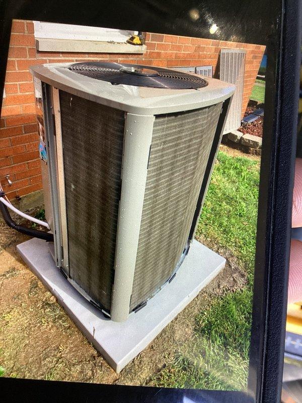Completed annual planned maintenance on residential HVAC system with outdoor condenser unit positioned on concrete pad adjacent to brick structure. Performed standard maintenance protocol including inspection of condenser coils which showed accumulated dust and environmental debris on metal mesh panels, verified refrigerant line connections along exterior wall, and assessed overall unit operation. System utilizes 16x25x5 PURE AIR filters as specified for this installation.
