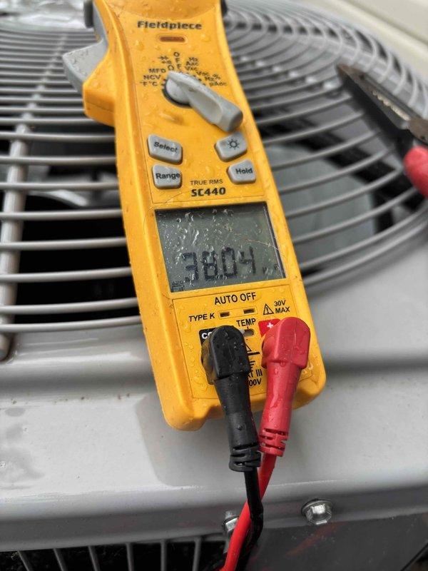 Completed scheduled air conditioning tune-up and preventive maintenance inspection. Performed comprehensive system evaluation including refrigerant line inspection, electrical measurements, and condenser coil assessment. All components operating within normal parameters; temperature readings confirmed proper system performance at 58.04°F, gas valve and connections inspected and found secure, and photographic documentation captured for maintenance records.