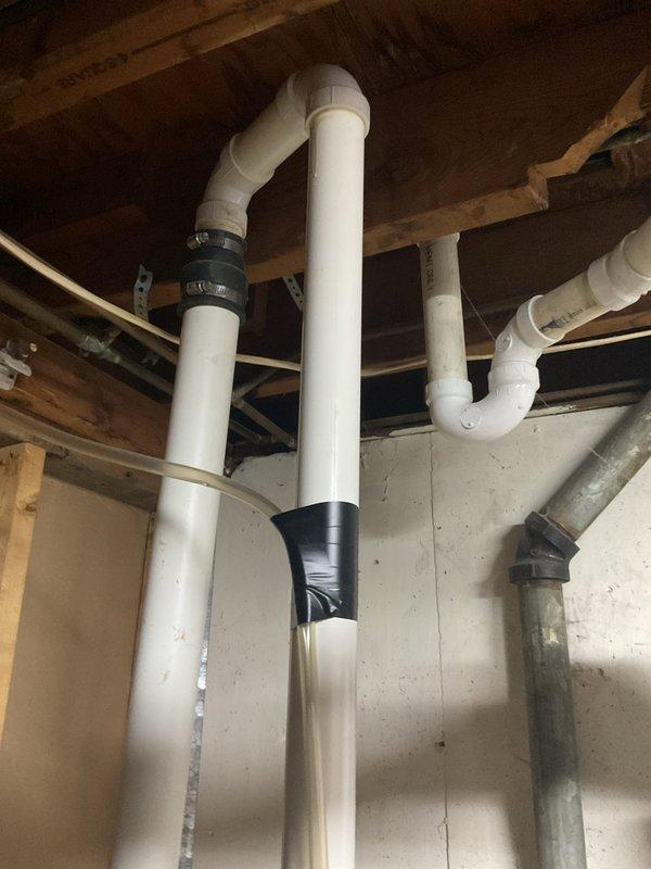 Completed comprehensive HVAC system replacement estimate for aging residential cooling system. Evaluated existing York brand outdoor condensing unit positioned on concrete pad against brick exterior, noting electrical disconnect and refrigerant line routing. Assessed interior components including basement installation with PVC condensate drainage system and associated plumbing connections. Provided detailed replacement recommendations for complete system upgrade to improve efficiency and reliability.