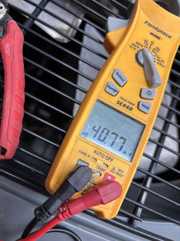 Completed annual AC tune-up maintenance on residential air conditioning system. Performed electrical diagnostics on outdoor condenser unit, recording voltage readings of 40.77 using digital multimeter, and measured supply air temperature at interior register confirming proper cooling output at 68.8°F. System operating within normal parameters with no deficiencies noted.