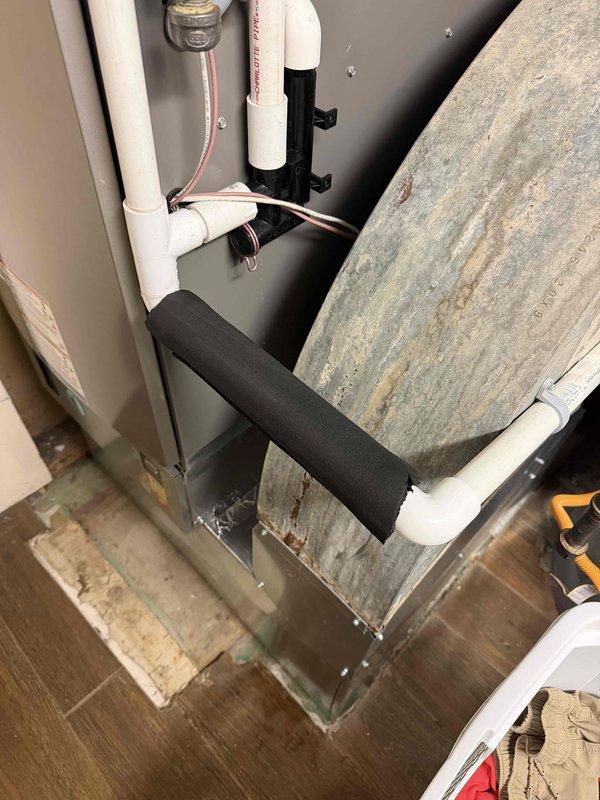 Responded to A+ callback for newly installed system experiencing short cycling and water leakage from furnace area. Upon arrival, found air handler with significant moisture damage and water staining on cabinet exterior and surrounding flooring. Inspected condensate drain system and discovered improper drainage causing water to overflow from drain pan. Cleared condensate line obstruction, verified proper trap installation, and confirmed drain line was flowing freely. Tested system operation through complete cooling cycle to ensure short cycling issue was resolved and no further water leakage occurred. System restored to proper working condition with adequate drainage and normal cycling performance.