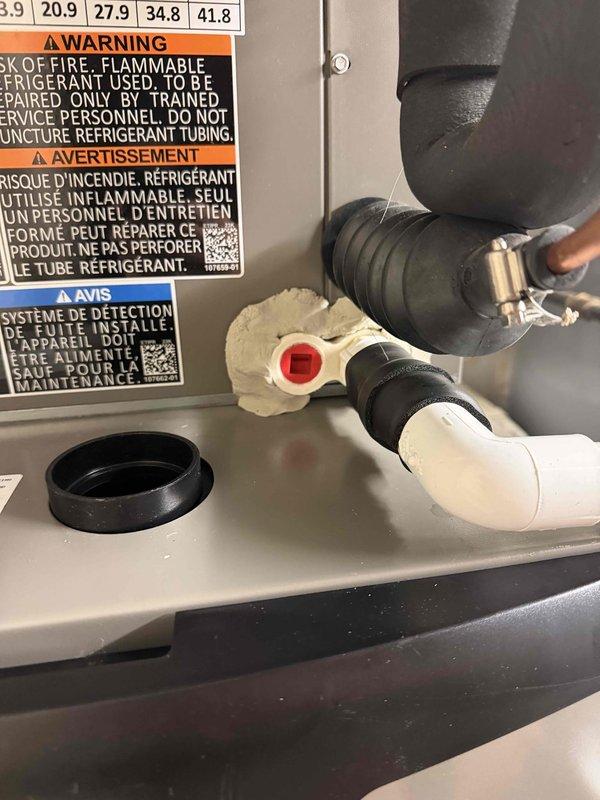Responded to A+ callback for newly installed system experiencing short cycling and water leakage from furnace area. Upon arrival, found air handler with significant moisture damage and water staining on cabinet exterior and surrounding flooring. Inspected condensate drain system and discovered improper drainage causing water to overflow from drain pan. Cleared condensate line obstruction, verified proper trap installation, and confirmed drain line was flowing freely. Tested system operation through complete cooling cycle to ensure short cycling issue was resolved and no further water leakage occurred. System restored to proper working condition with adequate drainage and normal cycling performance.