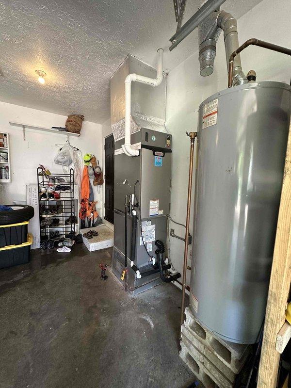 Completed installation of 3-ton Lennox HVAC system with 18 SEER efficiency rating in residential utility room. System includes new air handler unit and all associated ductwork connections, properly mounted and secured with manufacturer specifications verified. All equipment labeled, tested, and confirmed operational with proper airflow distribution throughout the home.