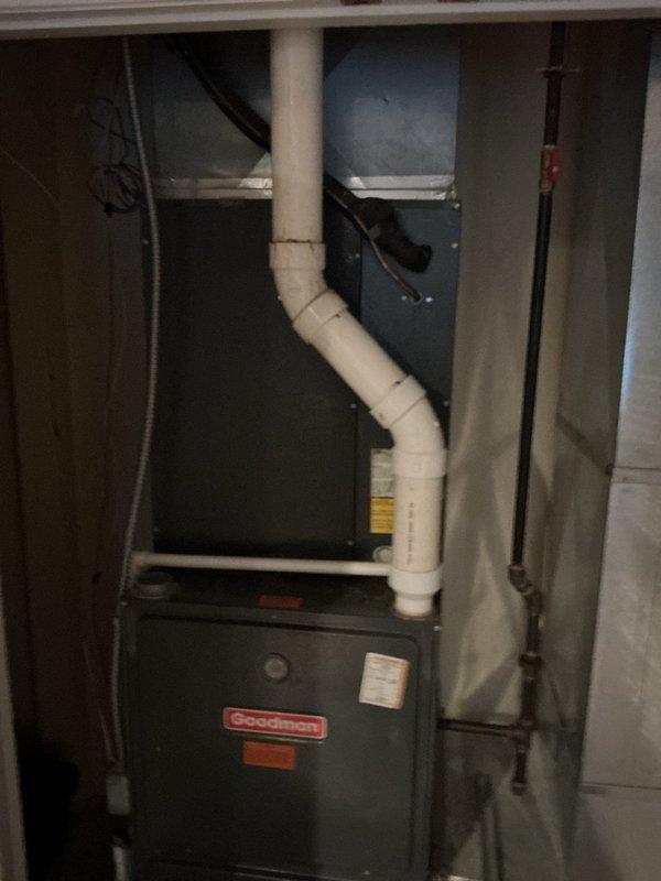 Completed comprehensive HVAC system replacement estimate for residential property with non-functional existing equipment. Evaluated current Goodman furnace and air handler installation located in basement utility area, along with outdoor condenser unit positioned on landscaped rock bed against exterior brick wall. Assessed existing system configuration including condensate drainage, refrigerant line routing, electrical connections, and overall equipment condition showing signs of age and weathering. Provided detailed replacement options and specifications for complete system upgrade to restore climate control functionality.