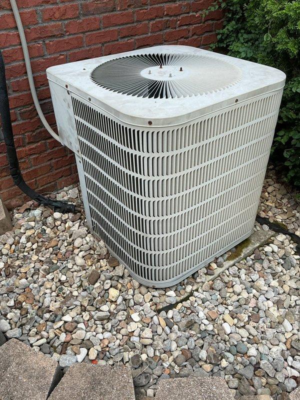 Completed comprehensive HVAC system replacement estimate for residential property with non-functional existing equipment. Evaluated current Goodman furnace and air handler installation located in basement utility area, along with outdoor condenser unit positioned on landscaped rock bed against exterior brick wall. Assessed existing system configuration including condensate drainage, refrigerant line routing, electrical connections, and overall equipment condition showing signs of age and weathering. Provided detailed replacement options and specifications for complete system upgrade to restore climate control functionality.