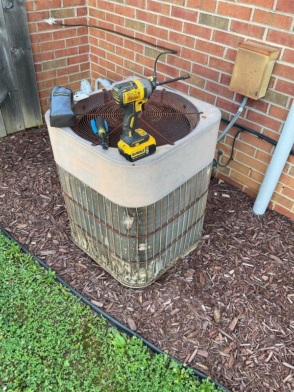 # HVAC Repair - No Cooling Issue Resolved

Responded to service call for 16-year-old residential air conditioning system with cooling failure. Customer reported compressor running and air handler blowing but no cold air production.

## Diagnostic Findings

Performed comprehensive system evaluation on aging split-system HVAC unit. Confirmed compressor operation and airflow from indoor air handler. Measured supply air temperature and verified inadequate cooling capacity. Inspected outdoor condenser unit positioned at exterior brick wall location. 

Tested electrical components, refrigerant pressures, and airflow characteristics. Identified loss of refrigerant charge as primary failure cause. Located refrigerant leak in system requiring repair. Assessed condenser coil condition and fan motor operation.

## Repairs Completed

Isolated refrigerant leak point and performed necessary repairs to restore system integrity. Evacuated remaining refrigerant from system following EPA guidelines. Com