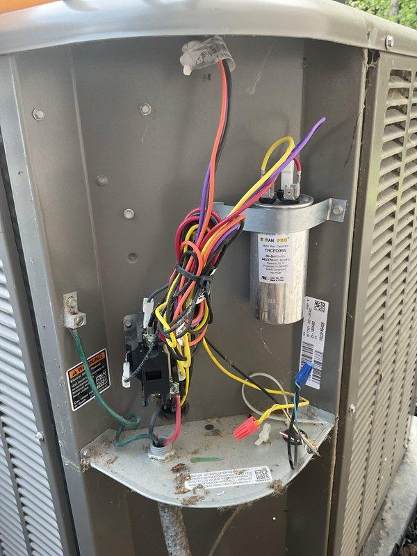 Responded to intermittent cooling issues on 2-year-old upstairs system that was randomly struggling to maintain temperature and occasionally requiring manual resets. Performed diagnostic inspection of outdoor unit electrical compartment, inspected TITAN capacitor, verified all electrical connections and terminals, and examined indoor control boards and wiring. Investigated reported loud noise from outdoor unit and assessed system performance to determine cause of intermittent operation.
