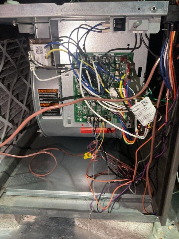 Responded to intermittent cooling issues on 2-year-old upstairs system that was randomly struggling to maintain temperature and occasionally requiring manual resets. Performed diagnostic inspection of outdoor unit electrical compartment, inspected TITAN capacitor, verified all electrical connections and terminals, and examined indoor control boards and wiring. Investigated reported loud noise from outdoor unit and assessed system performance to determine cause of intermittent operation.