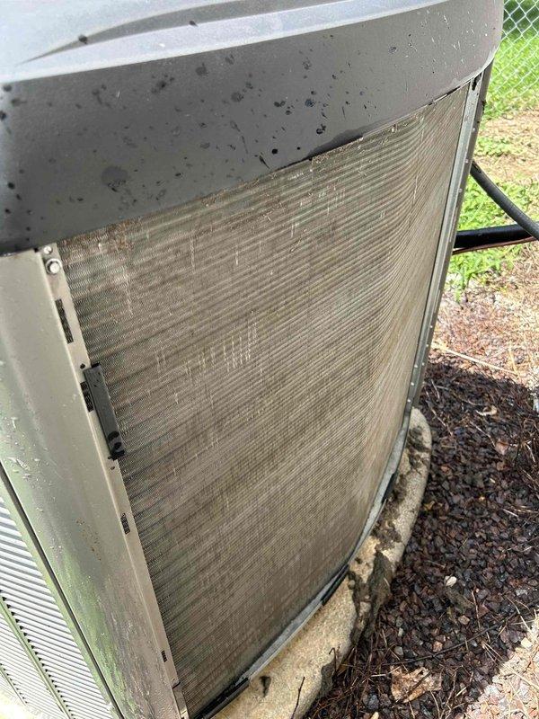 Responded to no cooling complaint on 2-year-old residential system with indoor temperature in mid-to-high 80s despite thermostat set to 68 degrees. Upon arrival, performed visual inspection of outdoor condensing unit and discovered heavily soiled condenser coil with significant dirt accumulation and organic debris restricting airflow through fins. Located and removed air filter which showed extreme contamination with thick layer of dust and particulate matter across entire surface, severely restricting system airflow. Restricted airflow from clogged filter caused inadequate heat exchange and system shutdown due to insufficient cooling capacity. Replaced dirty filter with new filter and cleaned condenser coil to restore proper airflow and heat transfer. System tested and verified operational with proper cooling restored to residence.