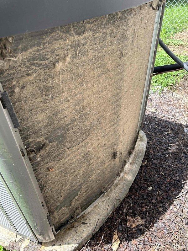 Responded to no cooling complaint on 2-year-old residential system with indoor temperature in mid-to-high 80s despite thermostat set to 68 degrees. Upon arrival, performed visual inspection of outdoor condensing unit and discovered heavily soiled condenser coil with significant dirt accumulation and organic debris restricting airflow through fins. Located and removed air filter which showed extreme contamination with thick layer of dust and particulate matter across entire surface, severely restricting system airflow. Restricted airflow from clogged filter caused inadequate heat exchange and system shutdown due to insufficient cooling capacity. Replaced dirty filter with new filter and cleaned condenser coil to restore proper airflow and heat transfer. System tested and verified operational with proper cooling restored to residence.