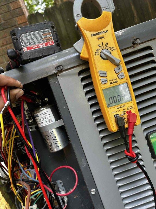 Responded to no-cooling call on 7-year-old residential system with thermostat set to 70°F and indoor temperature at 80°F. Found outdoor condensing unit not operating while indoor air handler was running. Performed electrical diagnostics using clamp meter, measuring amperage draw at contactor and capacitor connections. Inspected contactor operation, capacitor condition, and all electrical connections within disconnect box. Verified proper voltage supply to unit and tested all safety controls and components for proper functionality.
