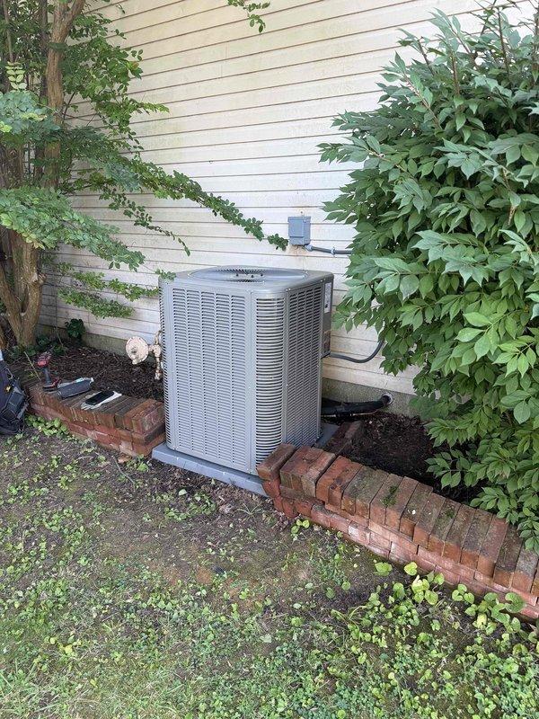 Completed full HVAC system installation including a 2-ton, 15.5 SEER outdoor condensing unit and 96% AFUE gas furnace. The outdoor unit was professionally positioned on a concrete pad against the residence exterior with proper clearances maintained from surrounding landscaping and structures. Electrical disconnect installed and properly mounted to exterior wall with secure conduit connections. Indoor furnace installed in utility area with new PVC venting routed through existing ductwork infrastructure. All refrigerant lines properly sized, insulated, and connected between indoor and outdoor components. System charged to manufacturer specifications and tested for proper operation. Verified airflow, temperature differentials, and combustion efficiency meet required standards. All electrical connections completed to code with proper grounding and circuit protection. Existing water heater and laundry appliances remain accessible with adequate service clearances maintained throughout instal