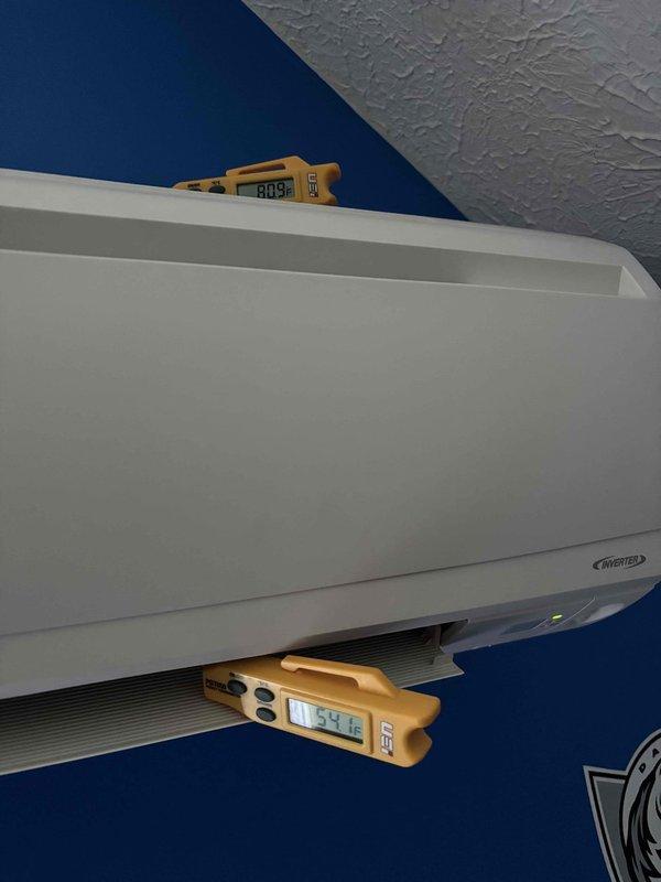 Responded to service call for 8-year-old mini-split system on east end of property experiencing condensation leakage from indoor wall-mounted unit. Upon arrival, performed diagnostic evaluation of the ductless inverter system which had been shut down by occupant due to water dripping concerns. Conducted temperature differential measurements at multiple points on the indoor air handler, recording supply air temperature of 60.3°F and return air readings. Inspected outdoor condenser unit positioned on concrete pad, verified proper operation and refrigerant line connections. No ice buildup was observed on the indoor unit, and main HVAC system remained operational as backup cooling source. Documented system conditions with thermal readings and exterior equipment placement for service records.