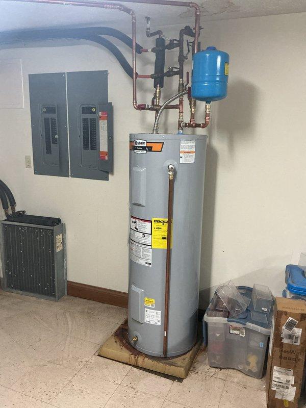 Installed a new 40-gallon residential water heater in utility room, including proper connection of hot and cold water supply lines with copper piping and flexible connectors. Mounted blue expansion tank near ceiling, integrated all plumbing connections to code specifications, and verified proper operation of all safety features and shut-off valves.