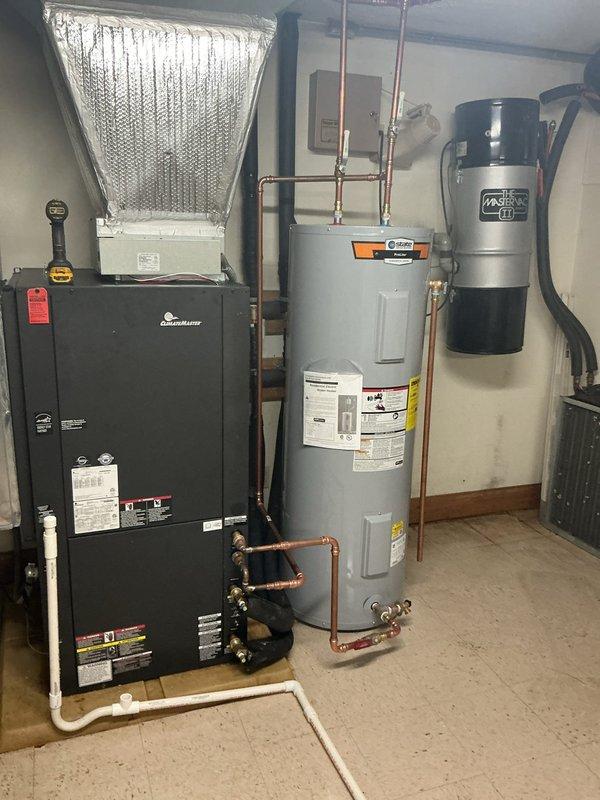 Installed a new 40-gallon residential water heater in utility room, including proper connection of hot and cold water supply lines with copper piping and flexible connectors. Mounted blue expansion tank near ceiling, integrated all plumbing connections to code specifications, and verified proper operation of all safety features and shut-off valves.