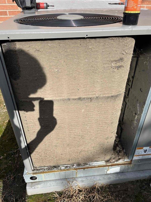 Responded to no cooling complaint on 2-year-old residential AC system affecting entire home. Upon inspection, discovered outdoor unit's air filter completely blocked with heavy accumulation of dirt, dust, and debris, severely restricting airflow and preventing proper system operation. Removed and replaced extremely clogged filter, restoring full airflow to condenser unit. System tested and confirmed cooling properly with adequate airflow and normal operating pressures.