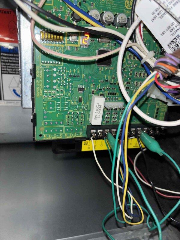 Responded to no cooling complaint on 3-year-old Lennox residential system with no airflow and indoor temperature reading 88°F with thermostat set to 79°F. Upon arrival, confirmed complete loss of airflow from supply vents with no breakers tripped. Performed diagnostic inspection of furnace and air handler assembly located in basement utility area. Accessed control board compartment and identified failed blower motor relay on integrated furnace control board preventing blower operation. Tested voltage supply to board confirming proper 24VAC from transformer and 120VAC line voltage present. Verified blower motor capacitor tested within acceptable range and motor windings showed proper resistance values, isolating failure to control board relay contacts. Replaced defective integrated furnace control board, reconnected all low voltage thermostat wiring and line voltage connections to blower motor assembly. Cycled system through complete operational test in cooling mode, confirmed proper bl