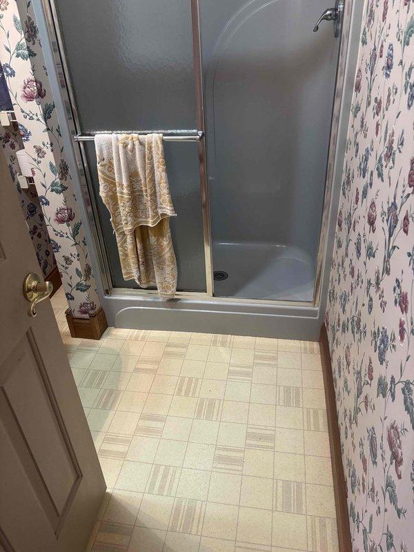 Conducted follow-up site visit to document bathroom conditions and verify accessibility for pending HVAC installation work. Photographed existing bathroom layout, including shower enclosure, flooring, and wall conditions to assess clearances and identify any potential obstacles for equipment placement or ductwork routing.