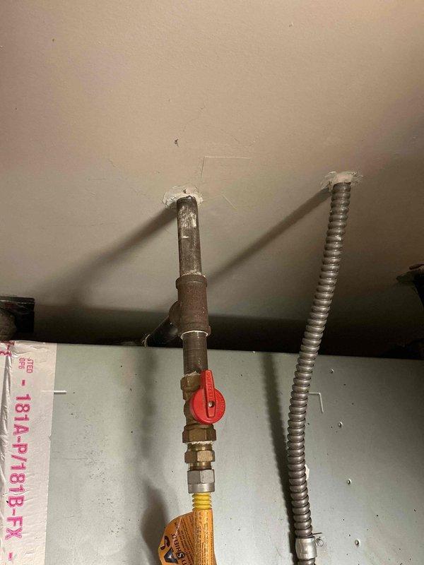Conducted comprehensive site evaluation for complete HVAC system replacement. Assessed existing outdoor condensing unit positioned on concrete pad against brick exterior, documented current electrical disconnect box and refrigerant line routing. Evaluated indoor gas line infrastructure including existing shutoff valve and flexible connector configuration where lines penetrate through ceiling. Captured detailed measurements and photographic documentation of both outdoor and indoor components to provide accurate equipment specifications and installation requirements for A+ rated energy-efficient system replacement estimate.