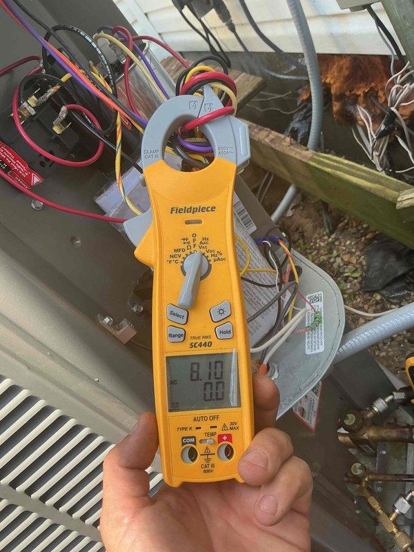 # HVAC Maintenance Completed

Performed planned preventative maintenance on residential HVAC system. Conducted comprehensive electrical diagnostics using clamp meter to verify system performance. Measured and recorded compressor amperage draw at 8.18 amps and supply voltage at 522 volts, confirming equipment operating within manufacturer specifications. Inspected capacitor connections and verified all electrical terminals secure with proper wire routing. Examined refrigerant line insulation for deterioration and checked copper tubing for signs of wear or damage. All components functioning properly with no deficiencies noted at time of inspection.