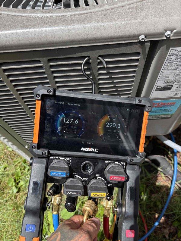 Responded to no cooling complaint on central air conditioning system previously installed by our company. Upon arrival, performed diagnostic testing using digital manifold gauge set to measure refrigerant pressures and temperatures. Low side pressure reading of 127.6 and high side pressure reading of 290.1 were recorded, indicating potential refrigerant charge issues or system performance concerns. Conducted visual inspection of outdoor condenser unit, which showed normal operation with no visible ice buildup on coils or refrigerant lines. Unit exterior displayed typical weathering consistent with outdoor installation. All diagnostic readings and equipment conditions were documented with photographs for service records. Homeowner was advised of findings and system status, with notation made regarding extended warranty coverage for any necessary repairs.