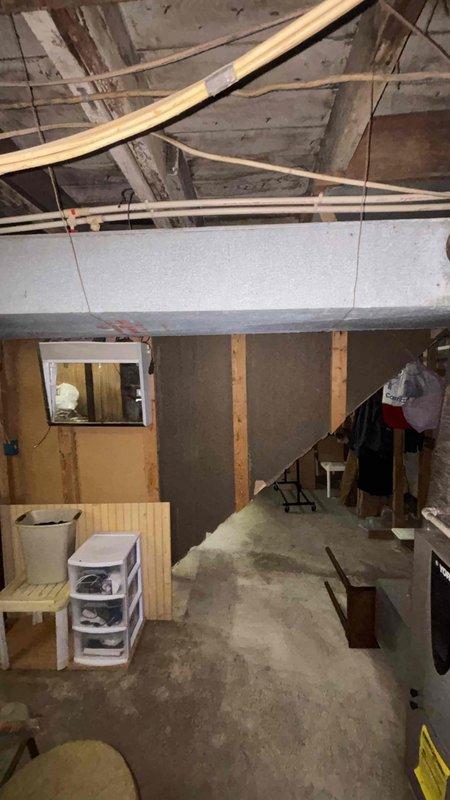Conducted comprehensive assessment of 25-year-old packaged cooling unit for small residential property (0-1000 sq.ft.). Evaluated existing system condition, noting aged equipment purchased used and nearing end of service life. Documented crawl space installation with evidence of moisture intrusion and water damage to surrounding structural components, including deteriorated flex ductwork with compromised insulation. Photographed basement area and underfloor access points to support replacement recommendation. Provided detailed estimate for complete HVAC system replacement with energy-efficient equipment suitable for property size and packaged unit configuration.