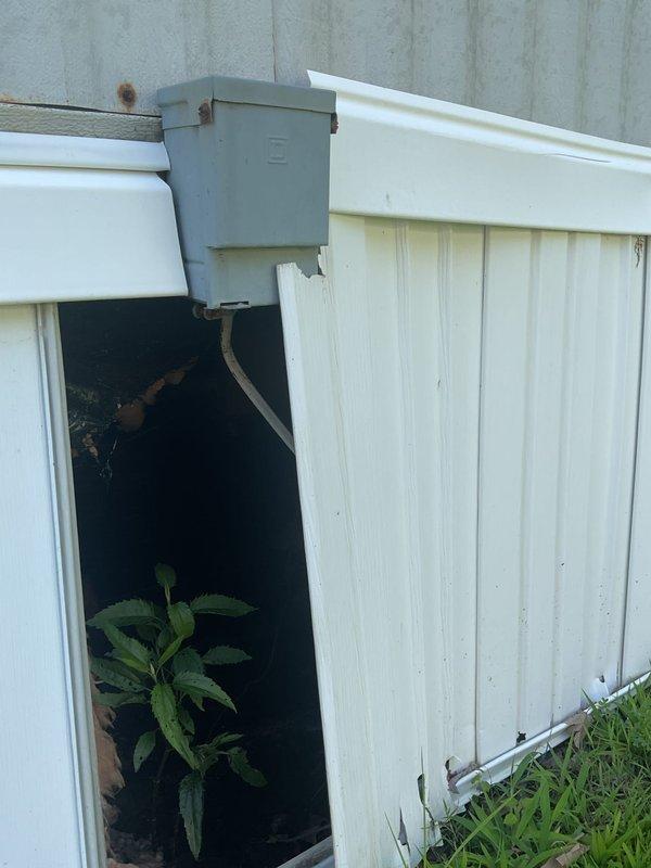 Completed on-site evaluation for central air conditioning installation in a small 3-bedroom mobile home with existing 8-year-old furnace system. Assessed exterior mounting locations, electrical service capacity, and documented current conditions of structure including weathered corrugated metal siding and utility connection points to determine equipment sizing requirements and installation feasibility for complete HVAC system upgrade.