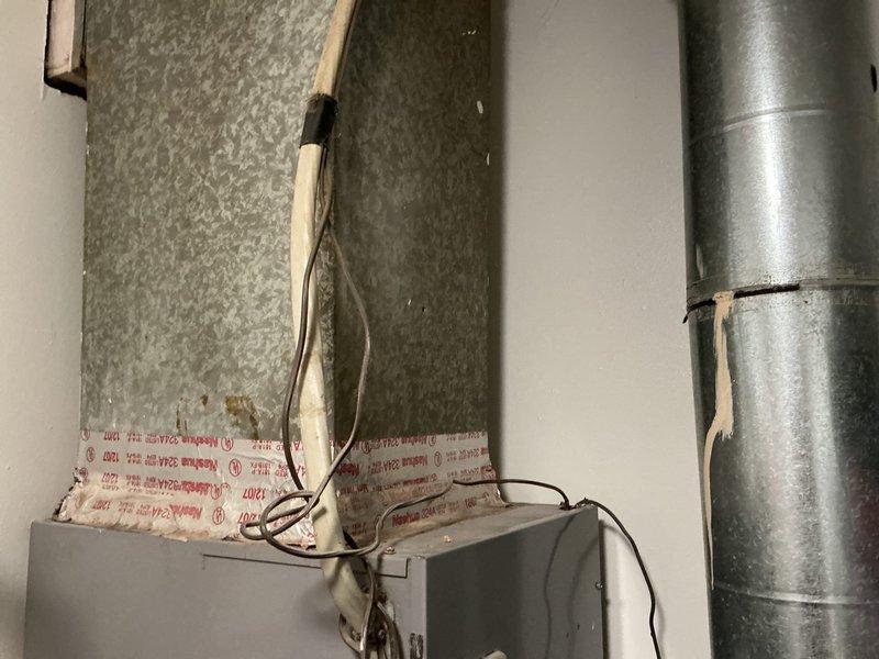 Conducted comprehensive estimate for complete HVAC system replacement on 18-year-old failed unit. Homeowner currently utilizing window units for temporary cooling due to system failure. Assessed existing equipment installation including air handler with ductwork connections, electrical components, and associated mechanical infrastructure in utility space. Evaluated water heater plumbing configuration and existing copper and PEX piping layout to coordinate bundled water heater promotion with air conditioning system replacement. Documented existing conditions through photographic survey of mechanical room showing air handler assembly, ductwork connections, electrical junction boxes, and plumbing infrastructure. Provided homeowner with equipment options and replacement recommendations for full system installation, discussing bundled water heater incentive program with new AC installation.