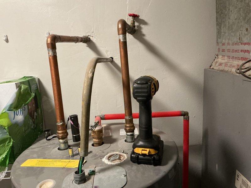 Conducted comprehensive estimate for complete HVAC system replacement on 18-year-old failed unit. Homeowner currently utilizing window units for temporary cooling due to system failure. Assessed existing equipment installation including air handler with ductwork connections, electrical components, and associated mechanical infrastructure in utility space. Evaluated water heater plumbing configuration and existing copper and PEX piping layout to coordinate bundled water heater promotion with air conditioning system replacement. Documented existing conditions through photographic survey of mechanical room showing air handler assembly, ductwork connections, electrical junction boxes, and plumbing infrastructure. Provided homeowner with equipment options and replacement recommendations for full system installation, discussing bundled water heater incentive program with new AC installation.