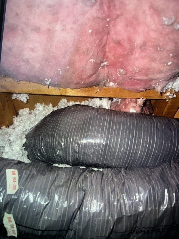 Responded to callback for water leak dripping from bathroom ceiling. Accessed attic space and inspected HVAC flexible ductwork and insulation. Located source of moisture intrusion affecting bathroom vent system. Documented existing conditions including flexible duct routing, insulation placement, and structural components. Verified ductwork installation and identified areas requiring correction to prevent continued condensation and water damage to ceiling below.