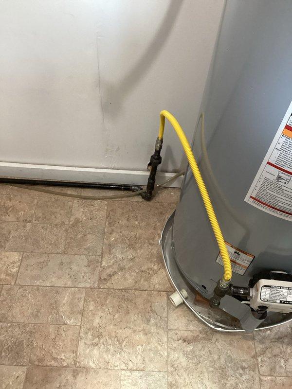Completed water heater replacement with upgraded gas supply infrastructure. Replaced 10 feet of existing gas pipe to properly accommodate new fixtures and ensure code-compliant installation. Installed new residential water heater with flexible yellow gas connector line and coordinated with HVAC technician for proper flue installation and venting. Total installation time approximately 4 hours including gas line modifications and system testing.