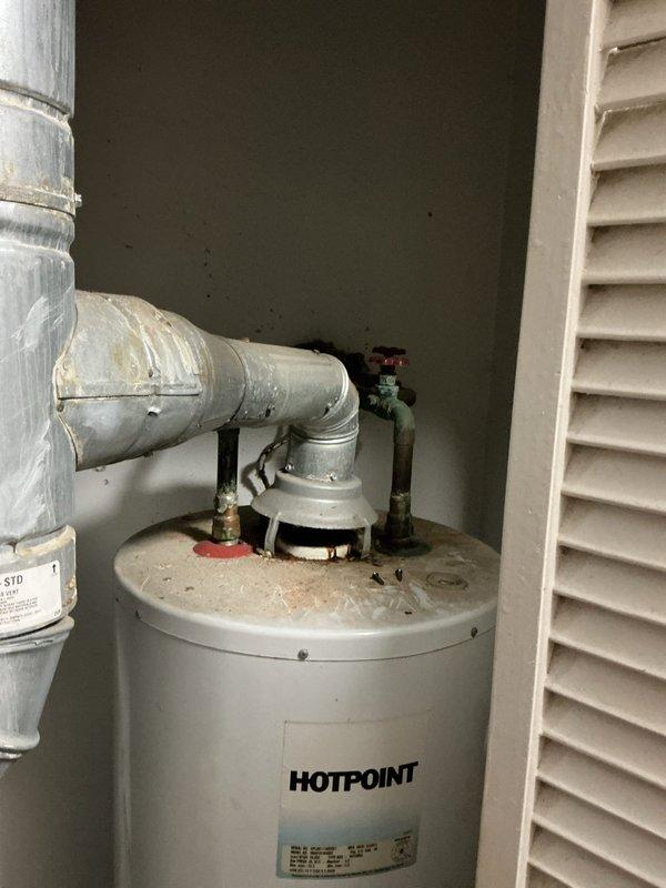 Assessed non-functional air conditioning system that is approximately 17 years old and provided replacement estimate. Documented existing HVAC equipment configuration including furnace installation and ductwork layout in utility area for sizing and equipment specifications.